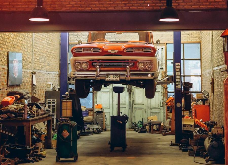 Classic car on a ramp inside a garage